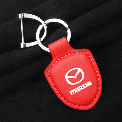 Porte-clés cuir noir emblème logo Mazda métal doré édition premium tous modèles - Mazdrive